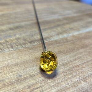 Yellow faceted glass hat pin